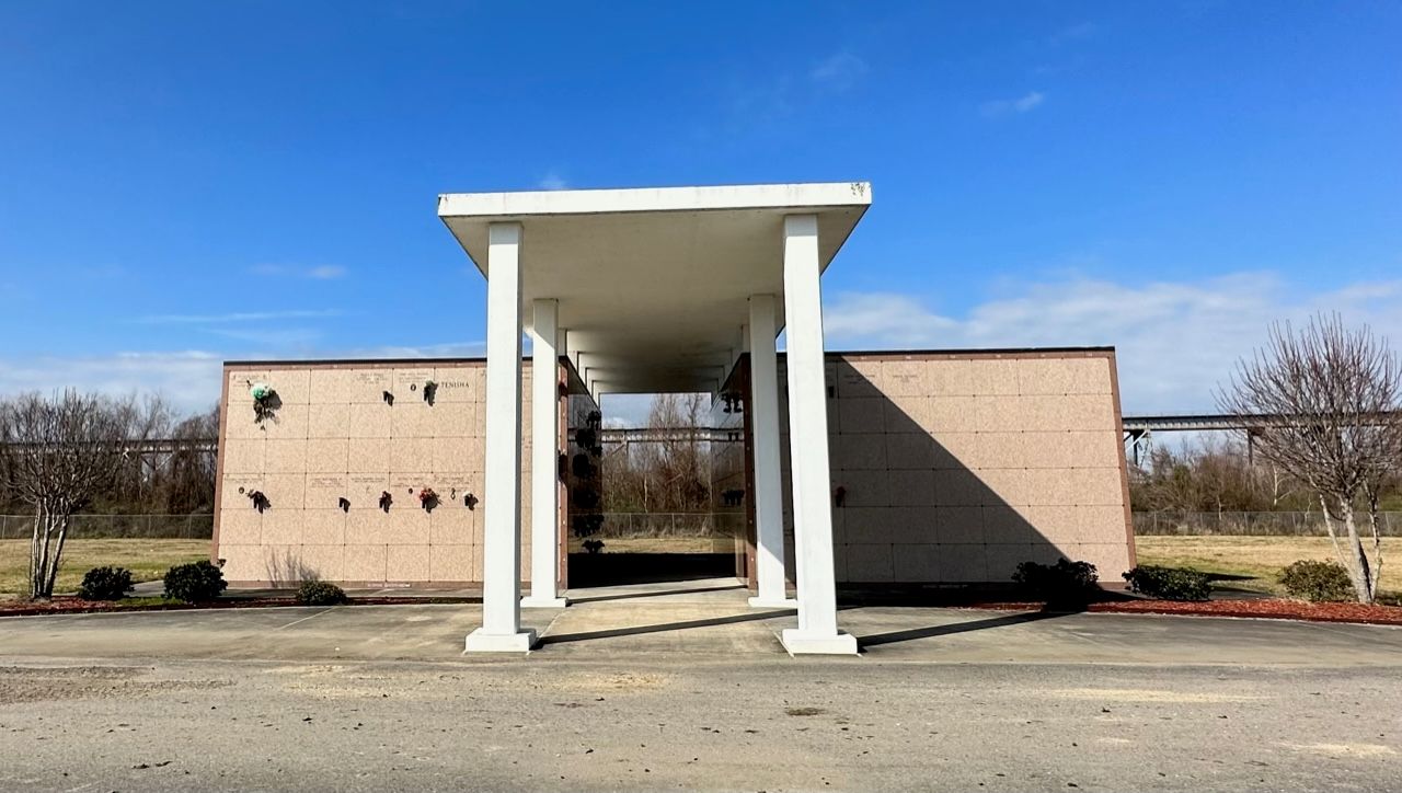 A building with a white canopy and columns in front of it.