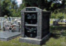 A cemetery with a telephone booth in the middle of it.