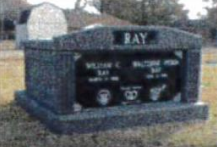 A gravestone in a cemetery with the name ray on it