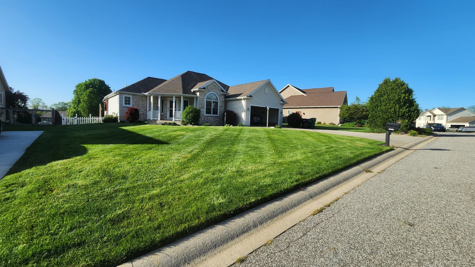 A house with a lush green lawn in front of it