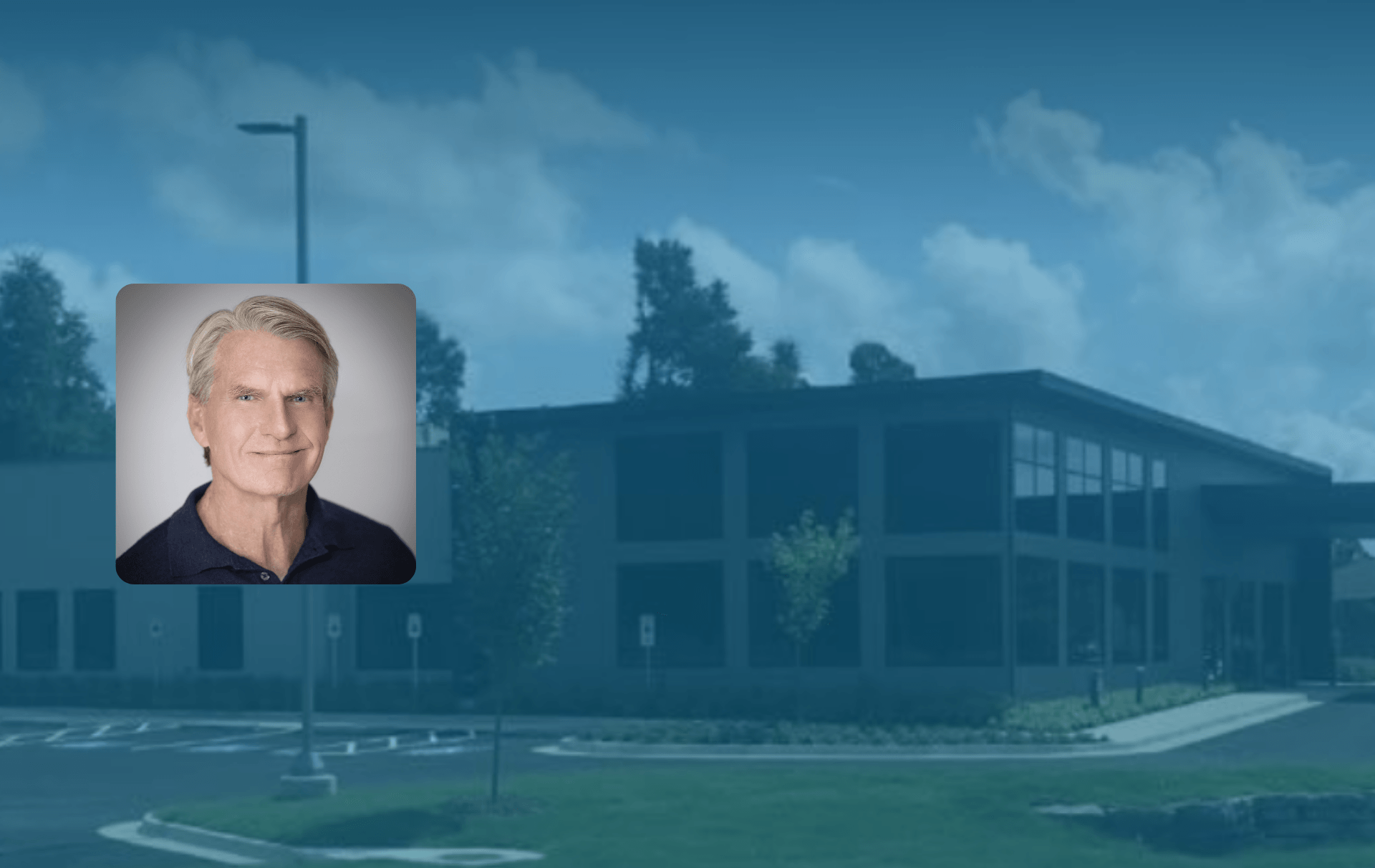 There is a picture of a man in front of a building.