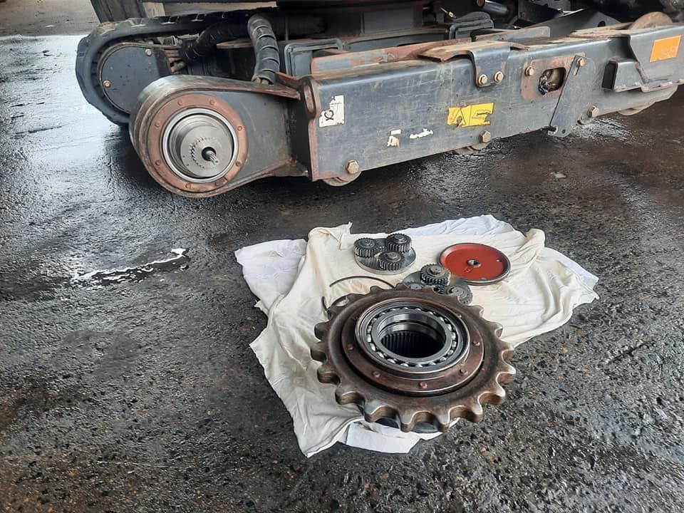 A Piece of Gear is Sitting on a Towel Next to a Machine — Giger Machinery Services in Bentley Park, QLD