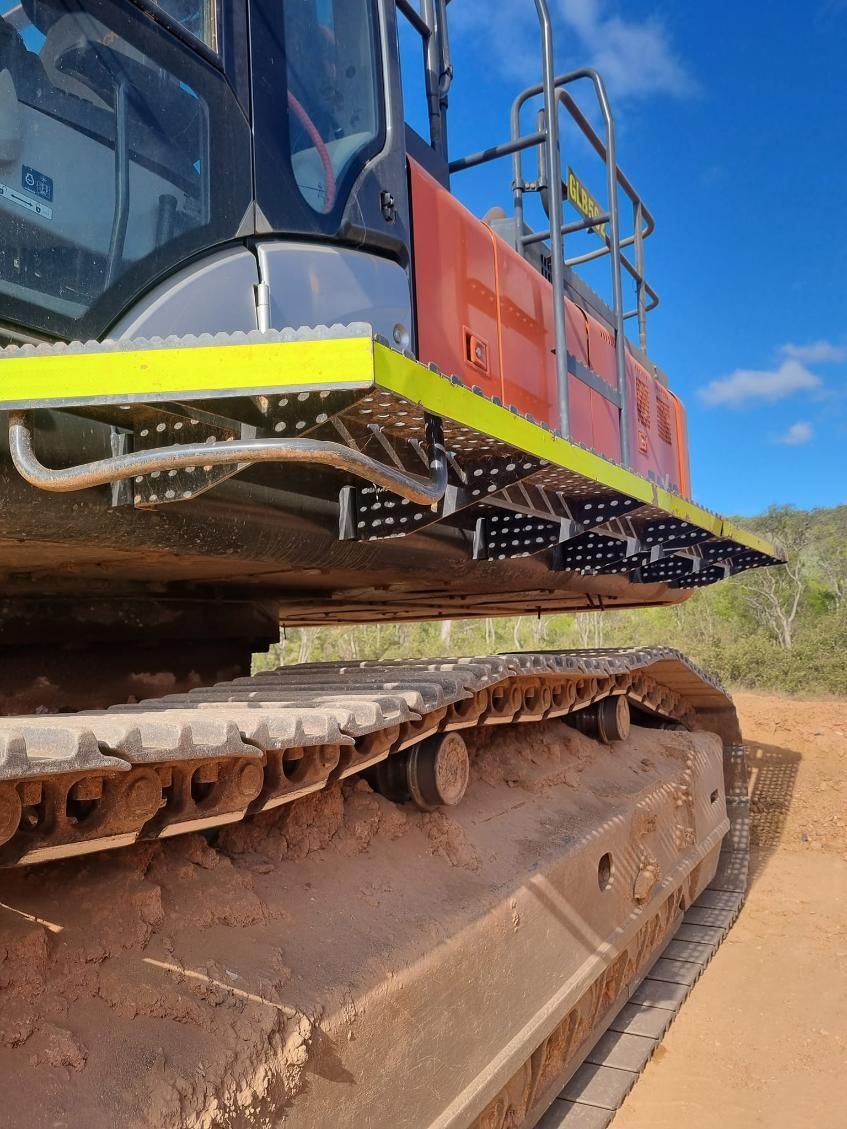 A Bulldozer is Parked on the Side of a Dirt Road — Giger Machinery Services in Bentley Park, QLD
