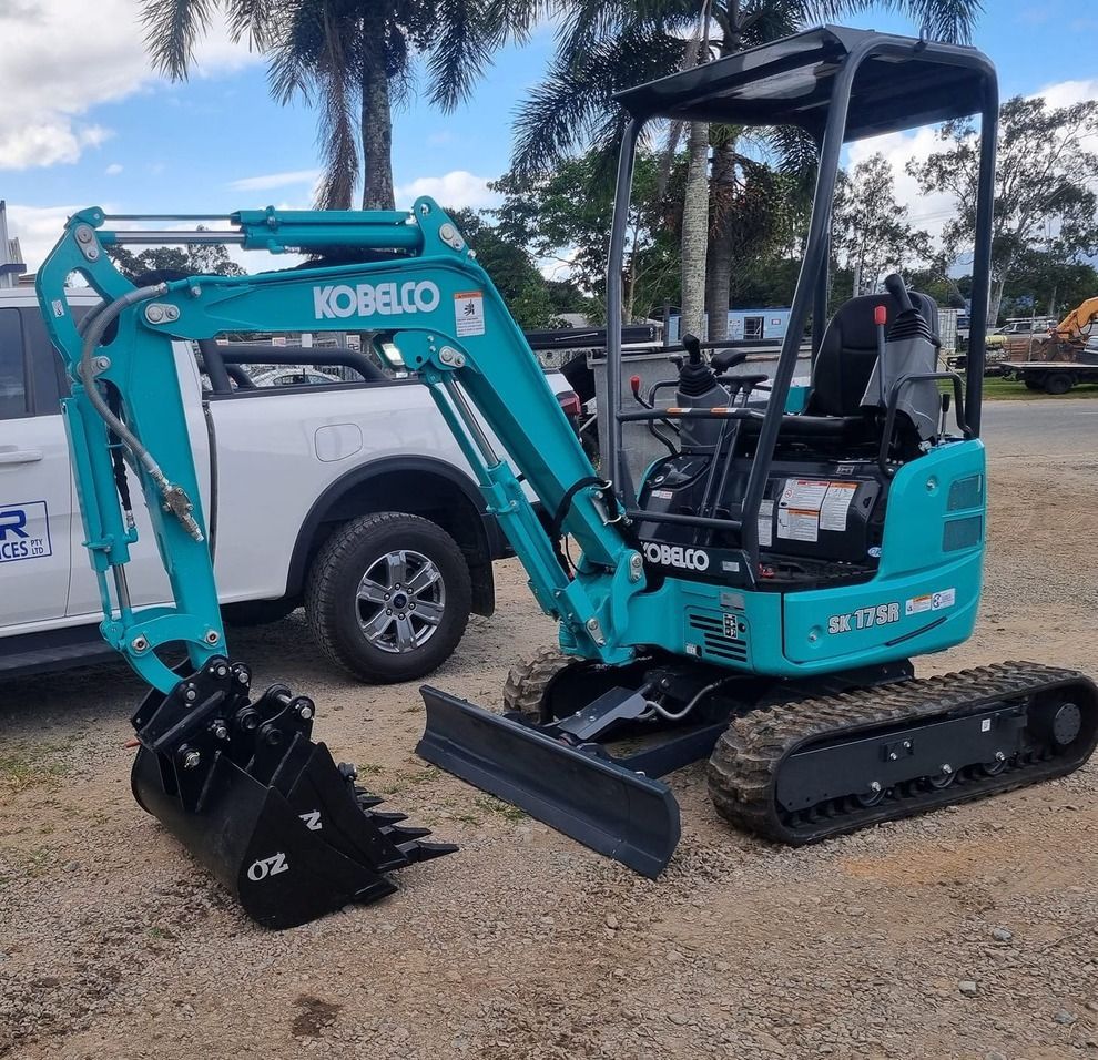 A Yellow Excavator Is Parked in Garage — Giger Machinery Services in Bentley Park, QLD