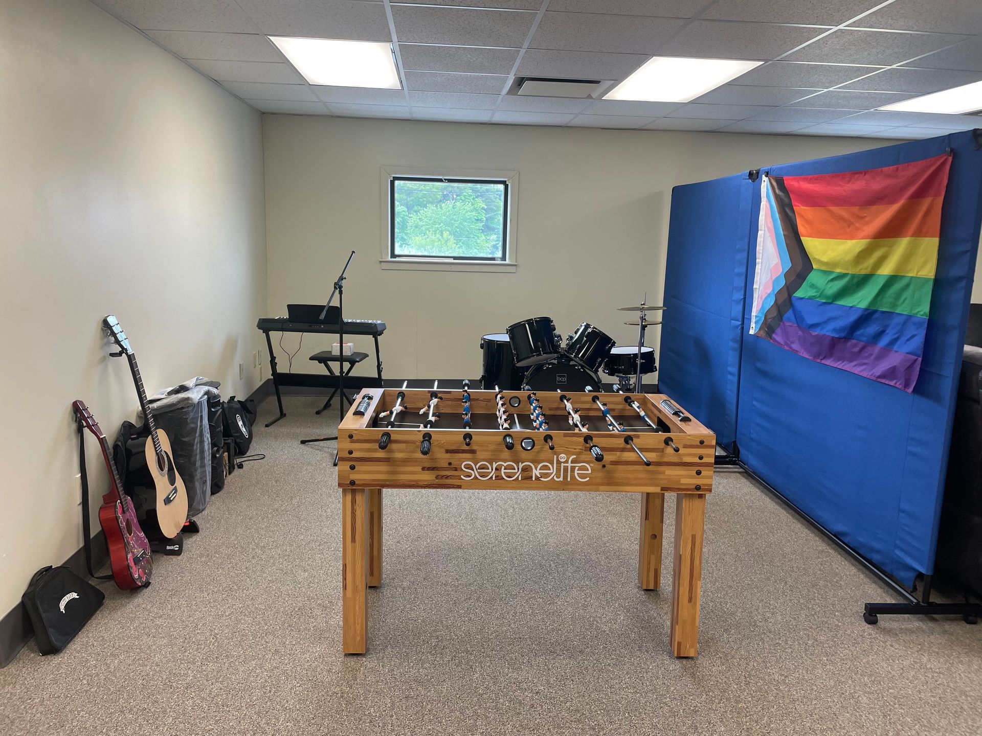 Music room at the Ware Family Resource Center with a pride flag and instruments