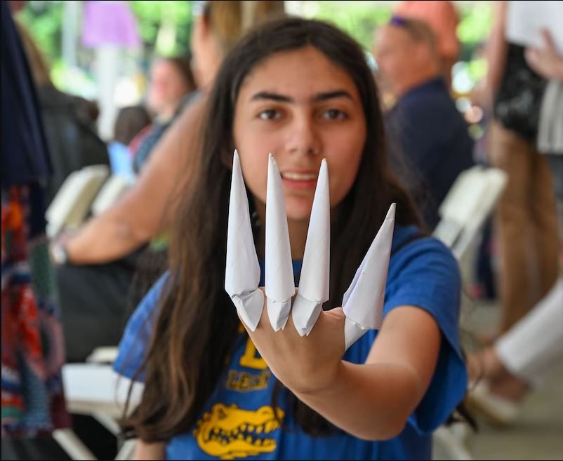 BHN kamp for kids opening day celebration - kids  posing with paper art
