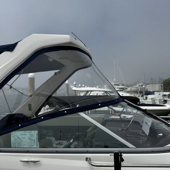 White boat cabin with clear windows, blue trim, and a cloudy sky background. White boat cabin with clear windows, blue trim, and a cloudy sky background.