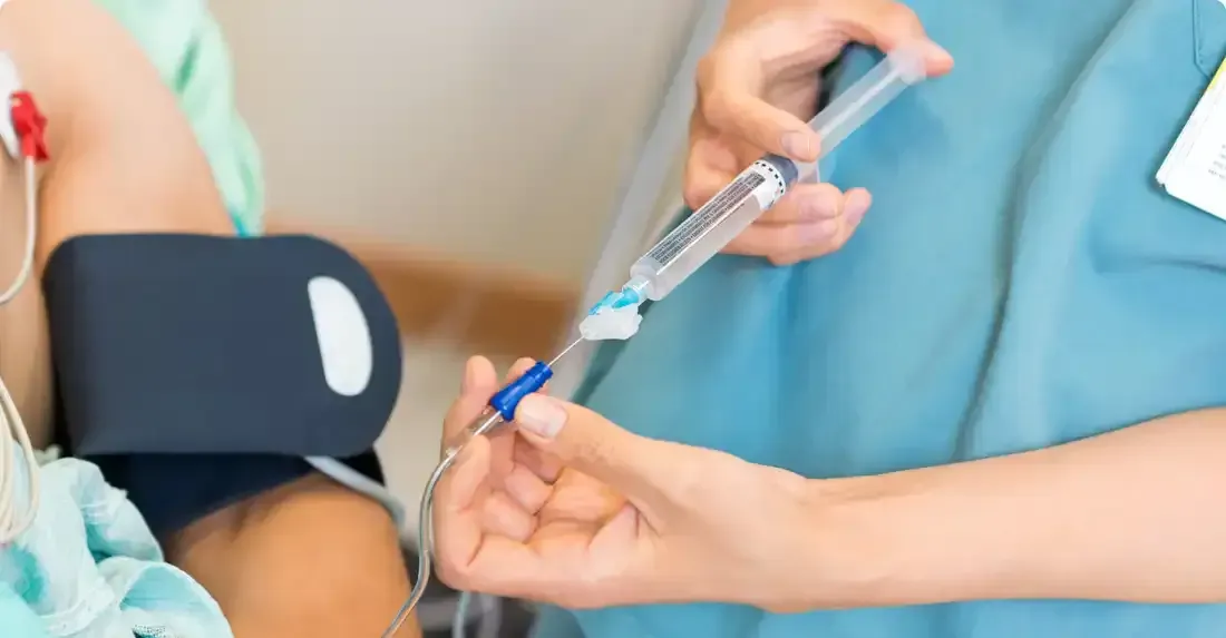 A nurse is giving an injection to a patient in a hospital.
