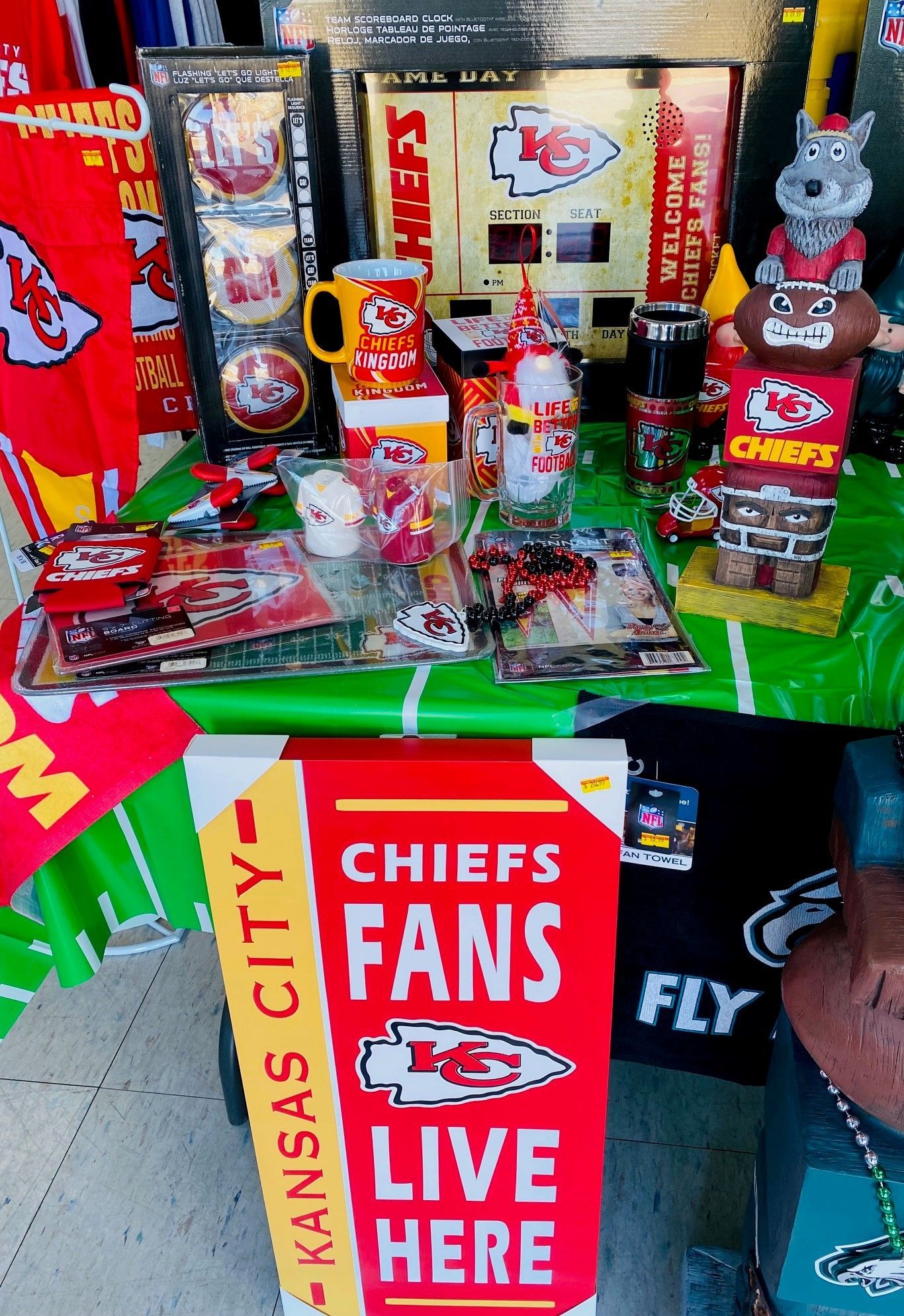 Kansas City Chiefs fan display with red merchandise, memorabilia, and a “Chiefs Fans Live Here” sign