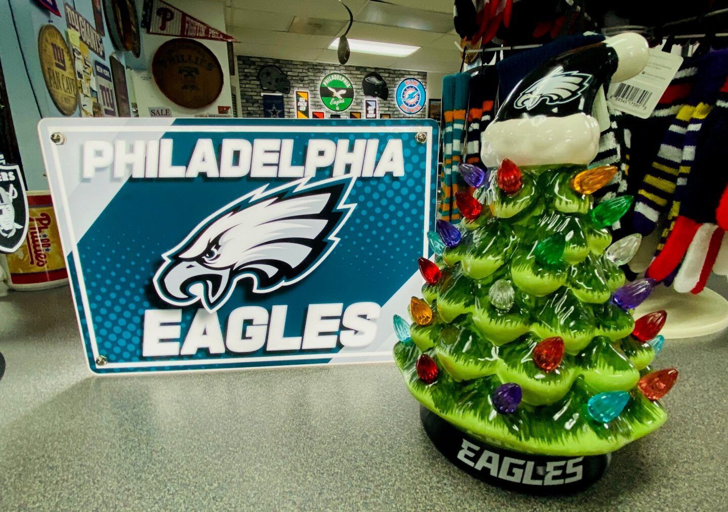Philadelphia Eagles sign and green Christmas tree decoration with red ornaments on a countertop