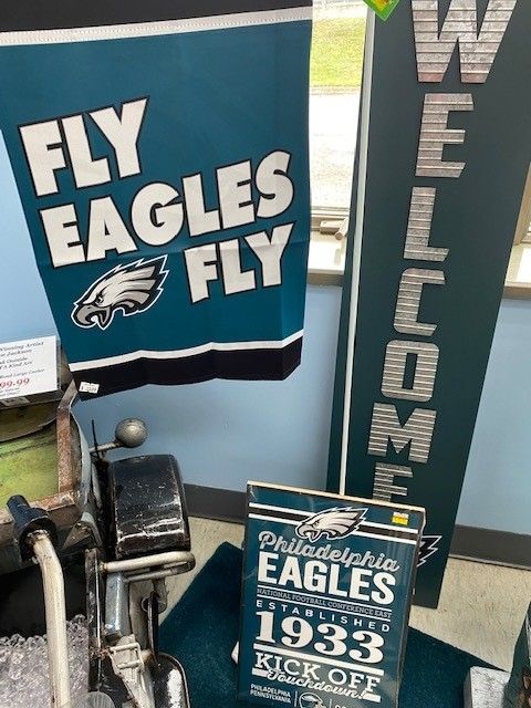 Philadelphia Eagles fan display with “Fly Eagles Fly” banner, “Welcome” sign, and 1933 championship plaque
