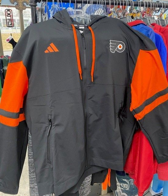 Black and orange Philadelphia Flyers jacket hanging on a clothing rack