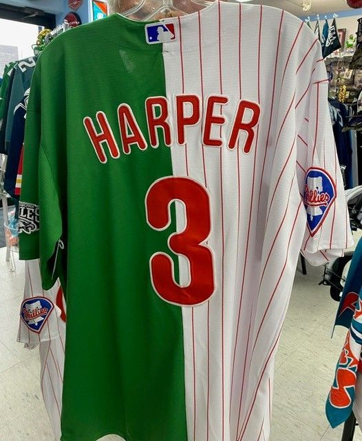 Phillies Harper #3 jersey, split green-and-white with red pinstripes, hanging in a store