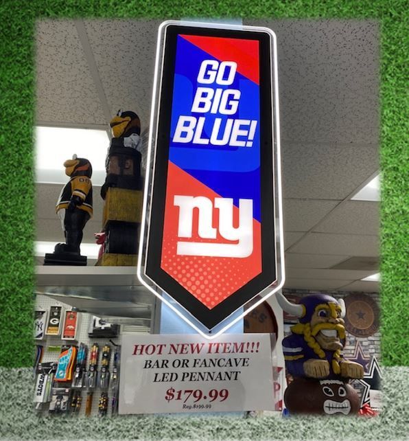 New York Giants “Go Big Blue!” sign above a store display with a $179.99 bar or fan cave LED pennant.