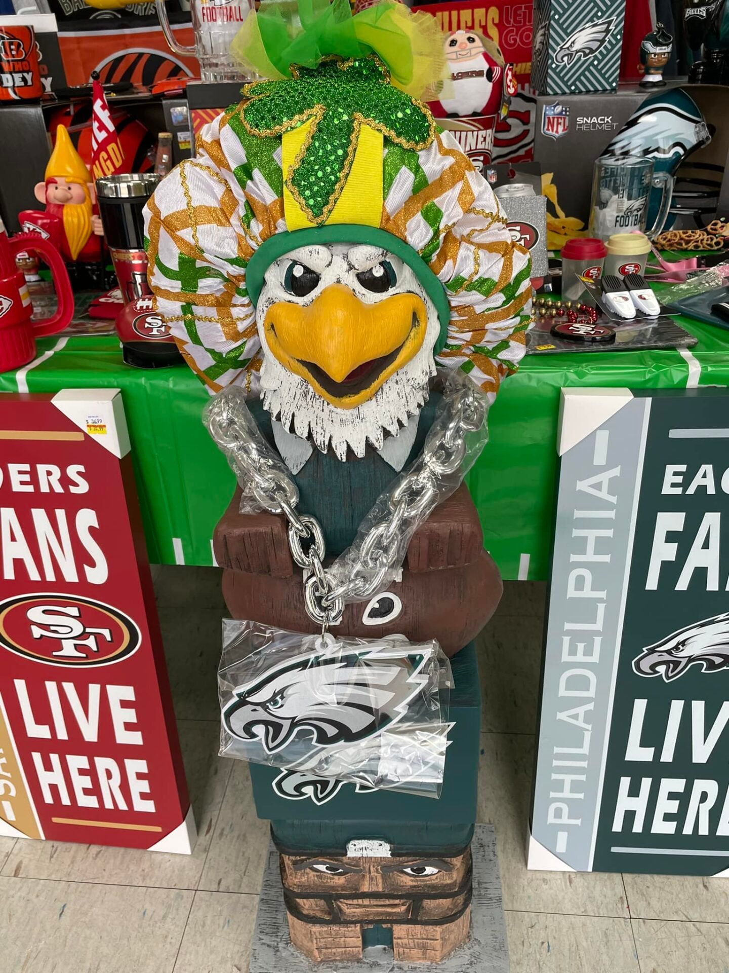 Philadelphia Eagles mascot statue in green, black, and gold at a stadium display with fan banners