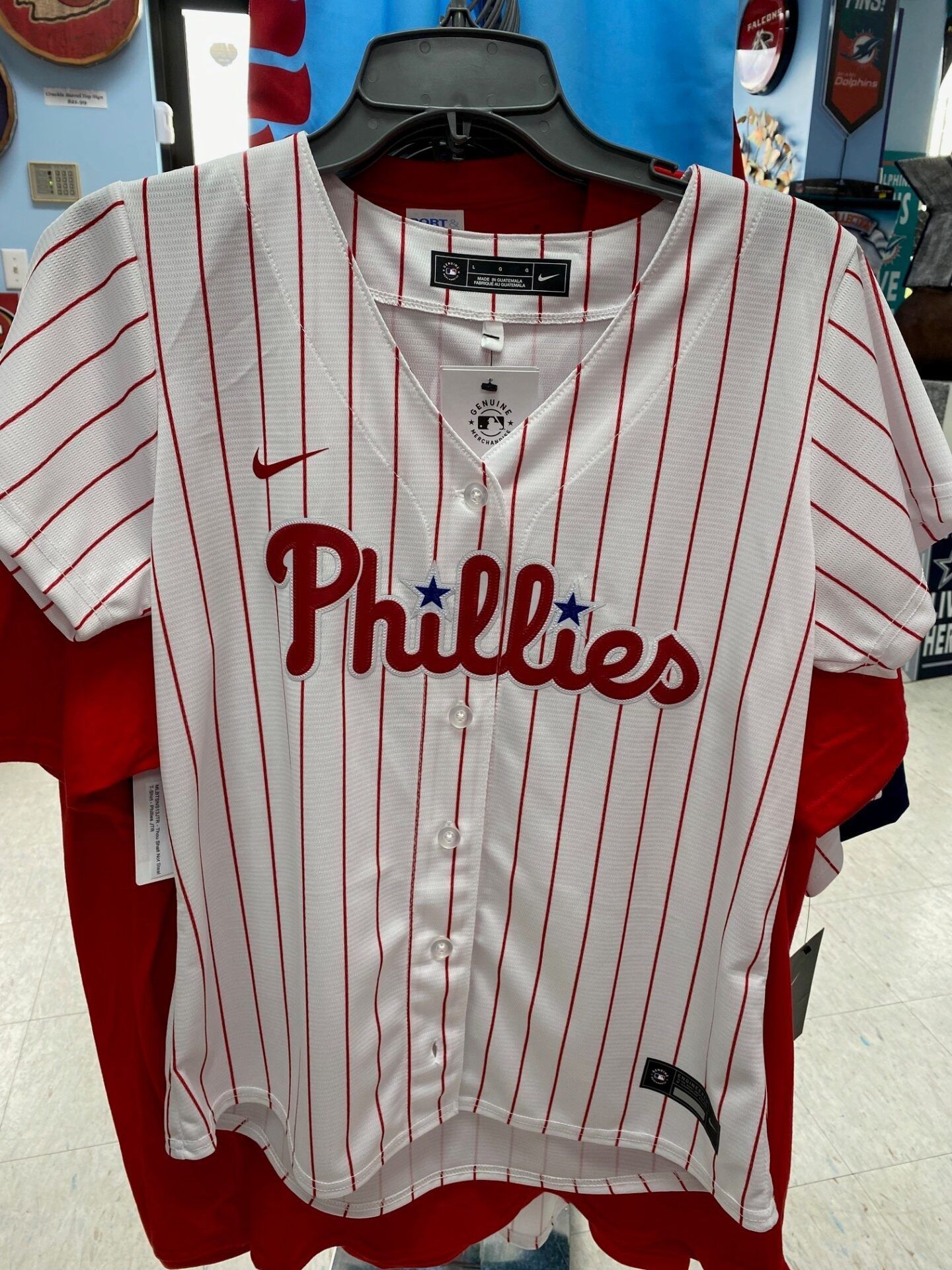 Philadelphia Phillies white pinstriped baseball jersey hanging on a hanger