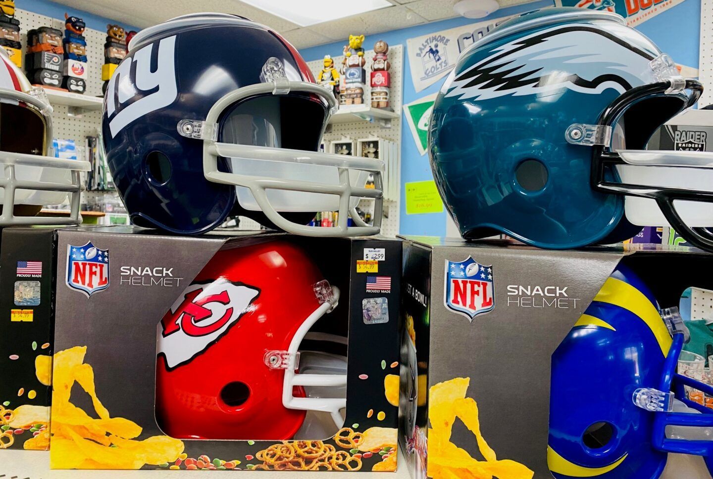 NFL snack helmets with New York Giants, Tennessee Titans, Kansas City Chiefs, and Los Angeles Rams logos.