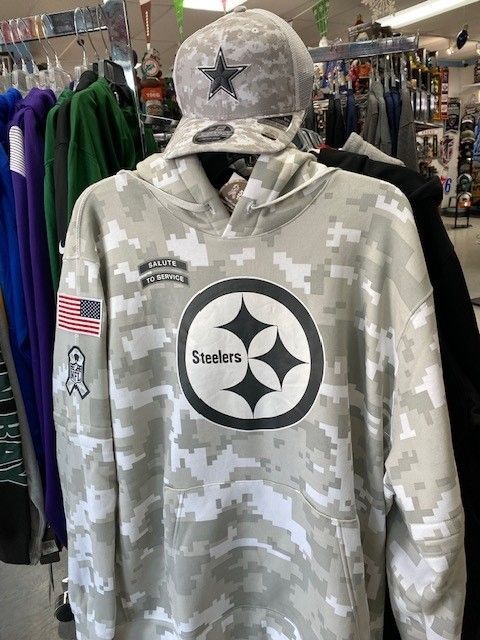 Camouflage Steelers hoodie on a rack, with matching cap and sports logos