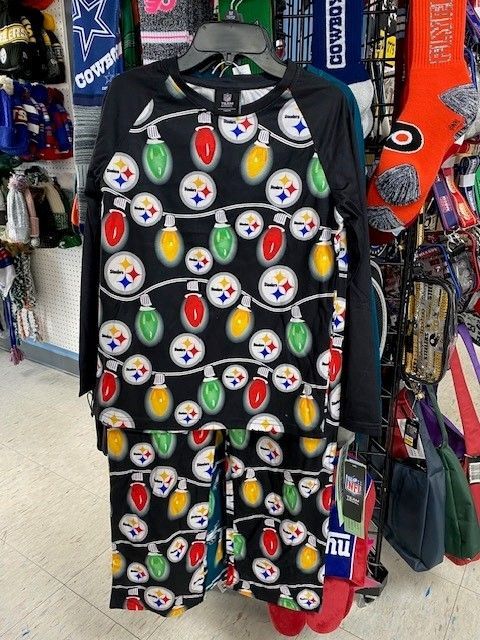 Pittsburgh Steelers-themed black shirt and pants set hanging on a store rack