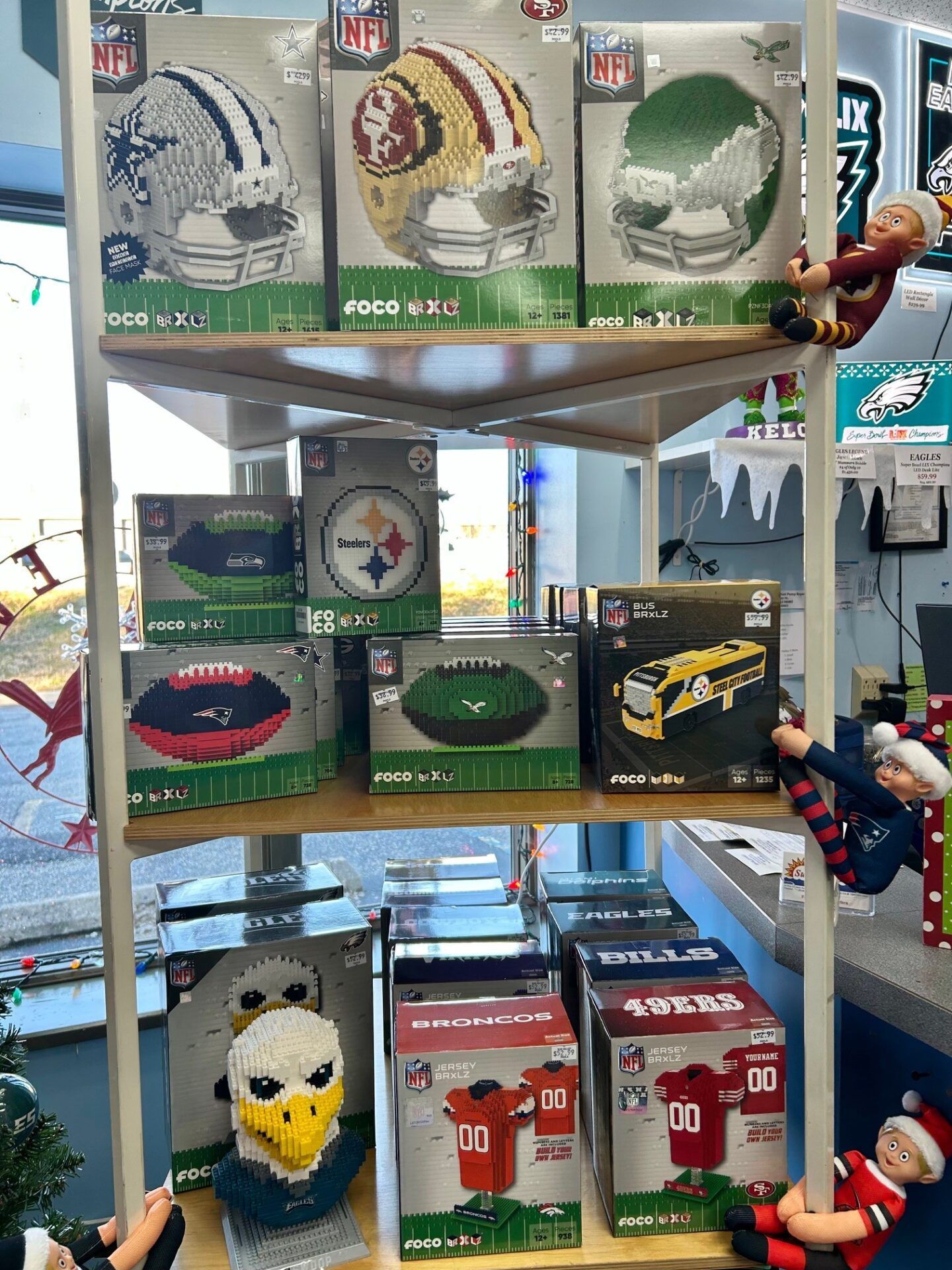 Store display of sports-themed gift boxes and plush toys on shelves