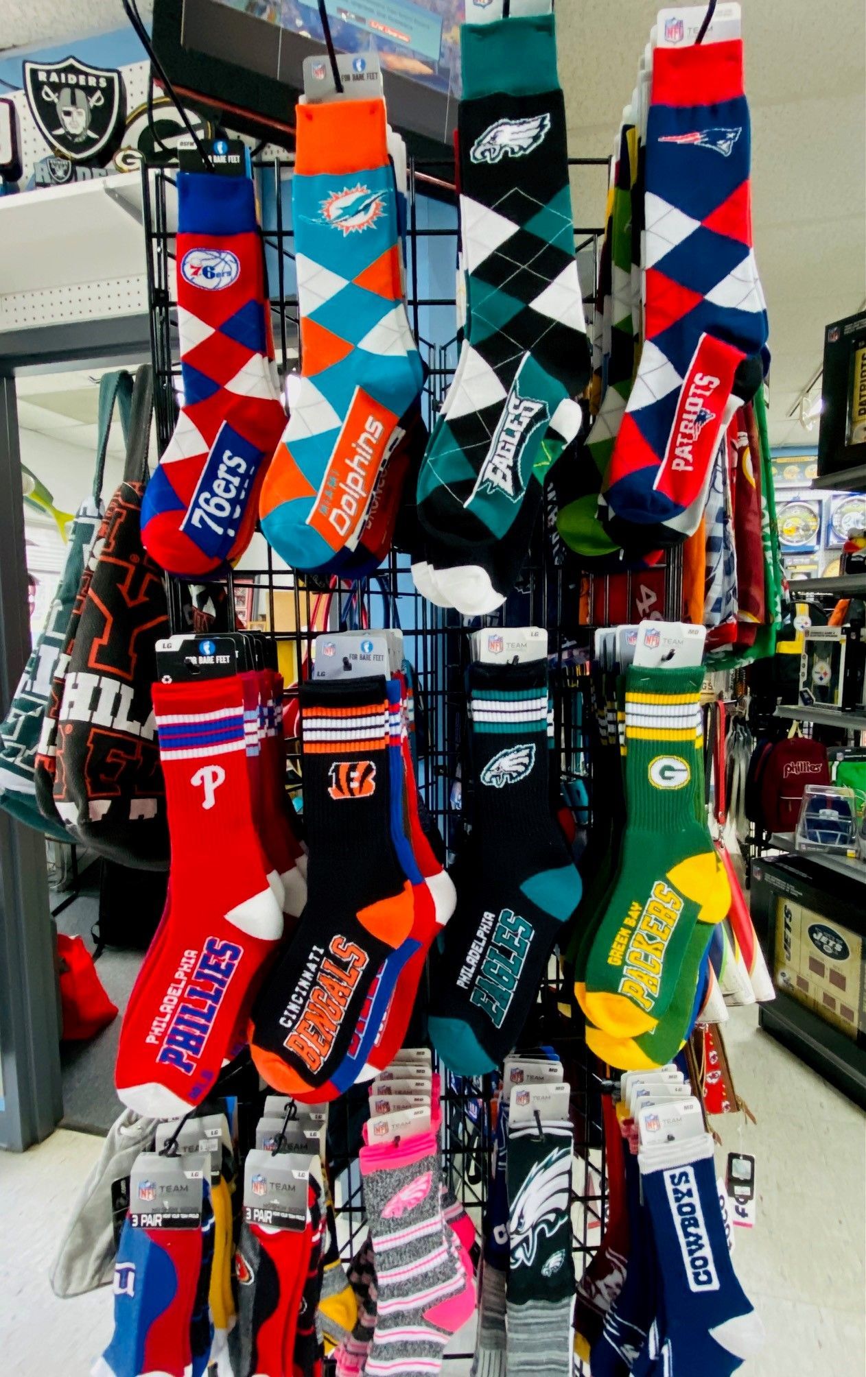 Colorful patterned socks hanging for sale on display rack at a market stall
