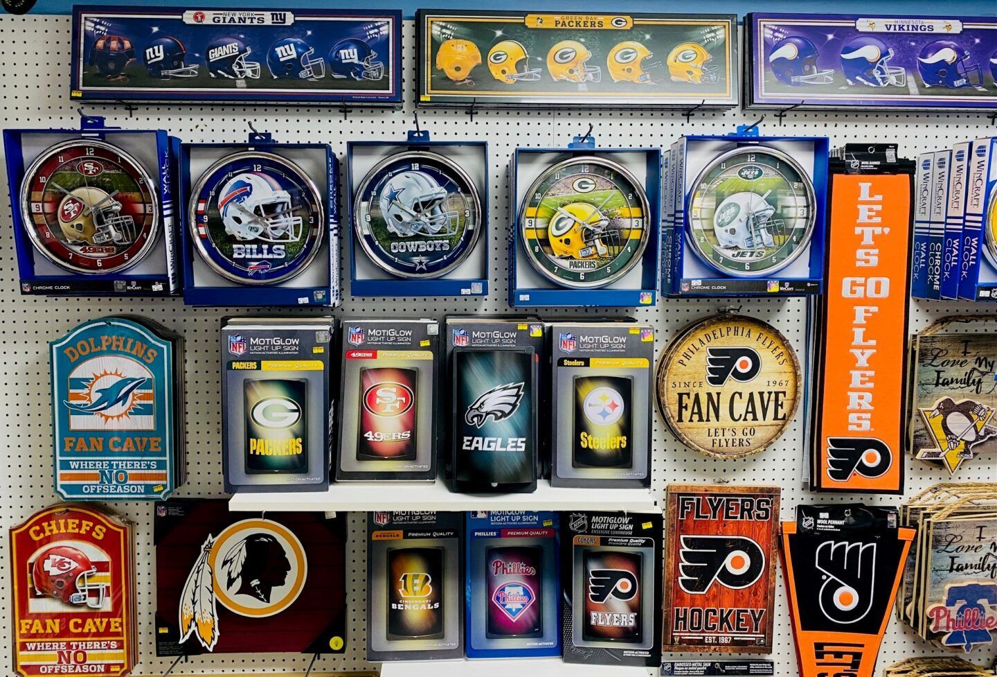 Assorted sports team memorabilia and logos displayed in a tight grid on a wall.