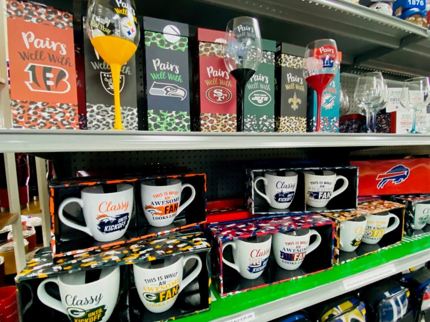 Shelves of colorful Paris-themed souvenir mugs and tumblers in a gift shop