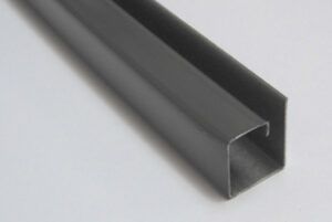Black rectangular metal channel profile with an open end on a light background