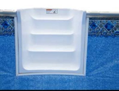 White pool skimmer door set in a blue tiled pool wall and waterline.