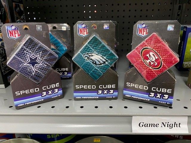 NFL Speed Cube puzzle boxes with Cowboys, Eagles, and 49ers logos on a store shelf in the Game Night section