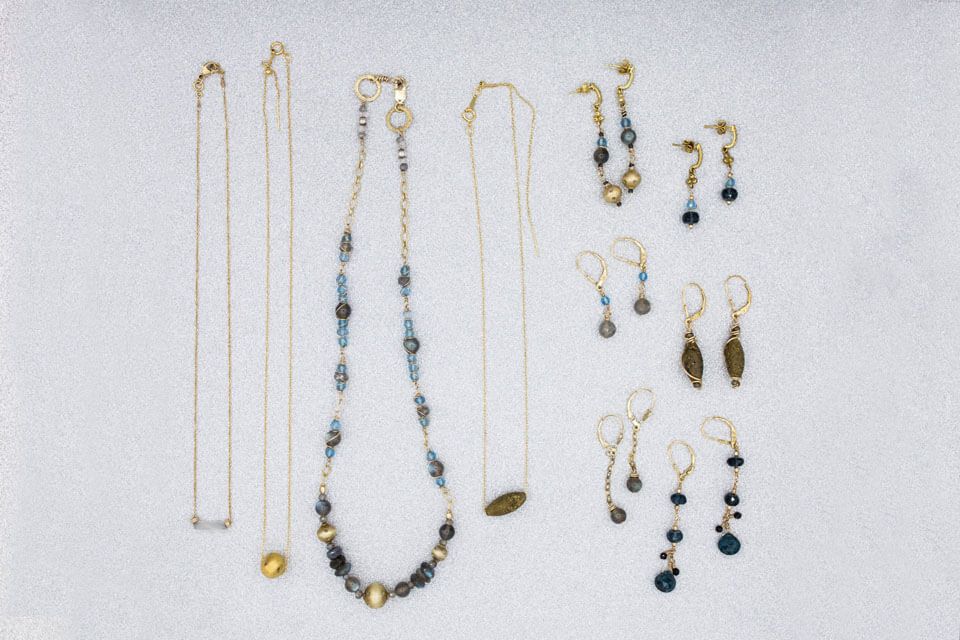 A collection of necklaces and earrings on a white surface