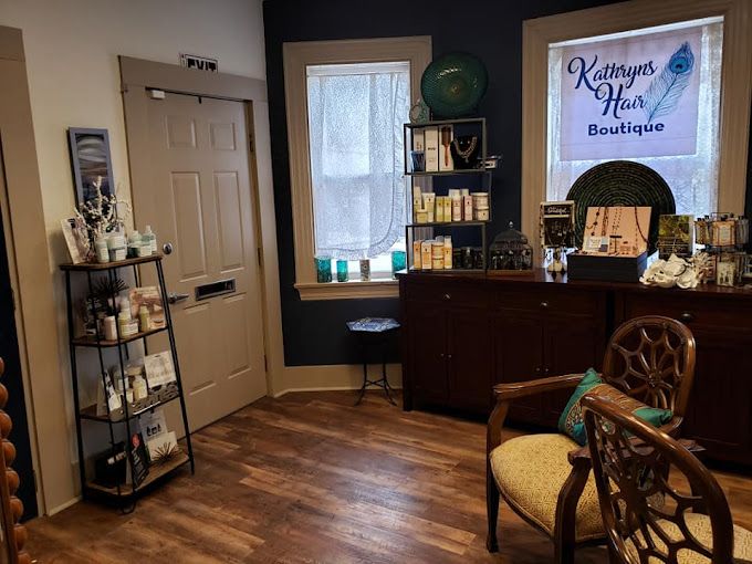 A room with a chair and a sign that says katingen hair boutique