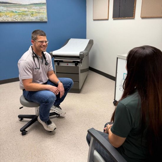 Doctor talking with a patient in a medical exam room
