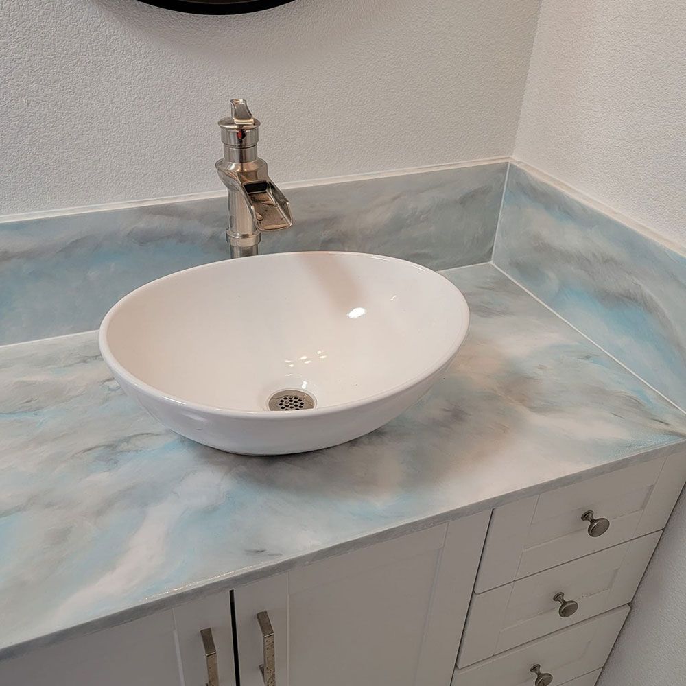 A bathroom sink with a faucet on top of a counter.