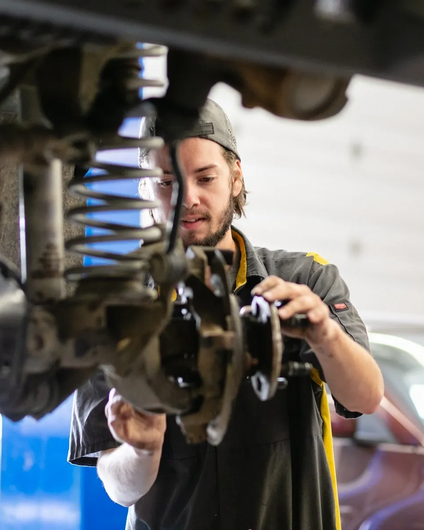 Mechanic Fixing Suspensions | Auto Repair At The Hive