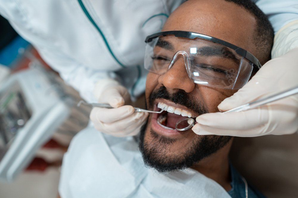 Man During A Dental Checkup — Palestine, TX — Forrest Westmoreland, DDS Man During A Dental Checkup — Palestine, TX — Forrest Westmoreland, DDS