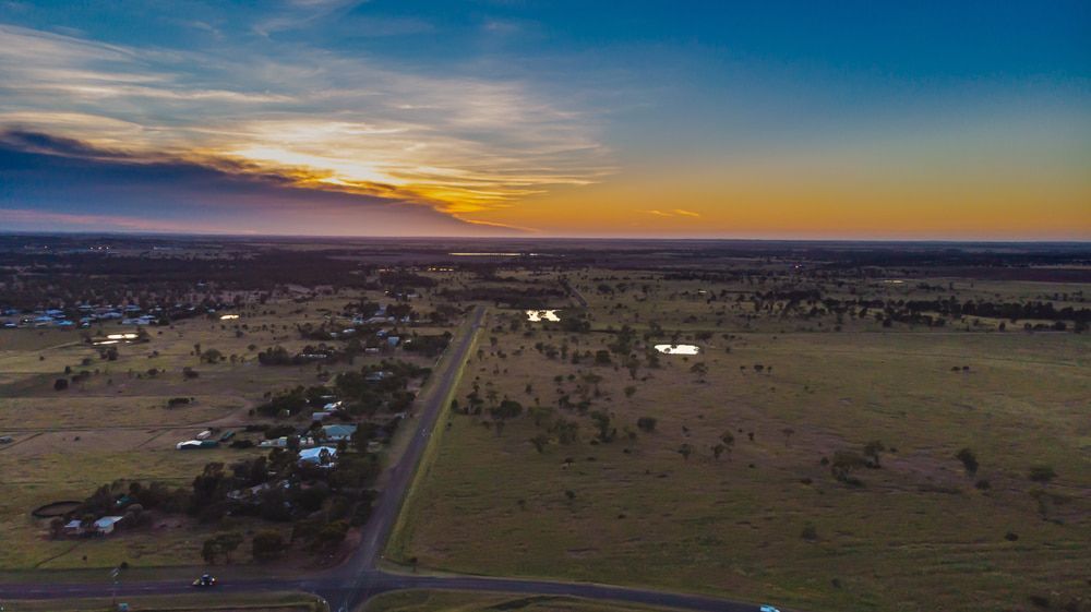 An Aerial View of A Road Going Through a Field at Sunset — Sportstar Screenprinting in Roma, QLD