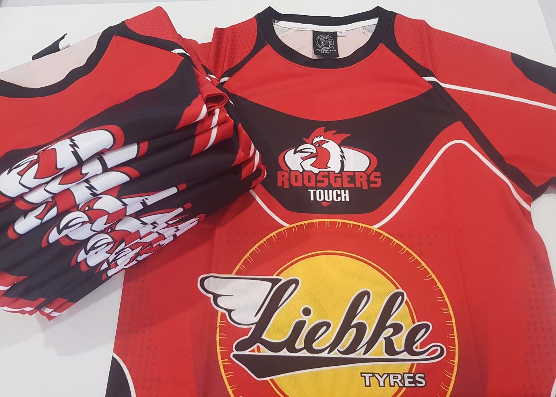 A Stack Of Red And Black Shirts With The Word Liefke On Them — Sportstar Screenprinting In Newtown, QLD