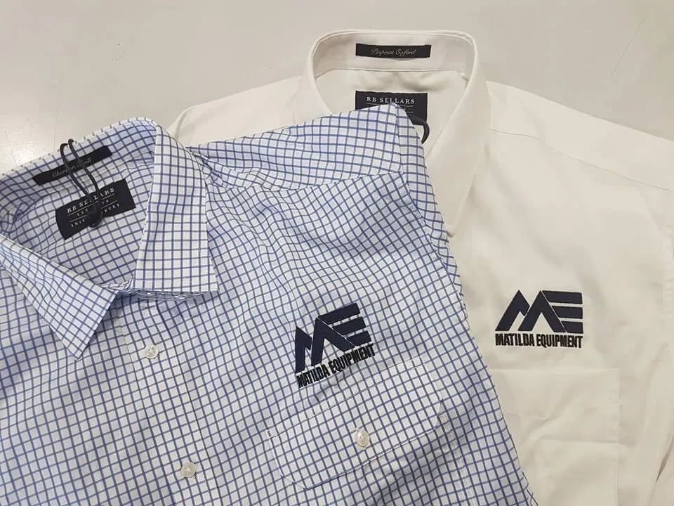 Two Shirts With The Word Matilda Equipment On Them Are Sitting On A Table — Sportstar Screenprinting In Newtown, QLD
