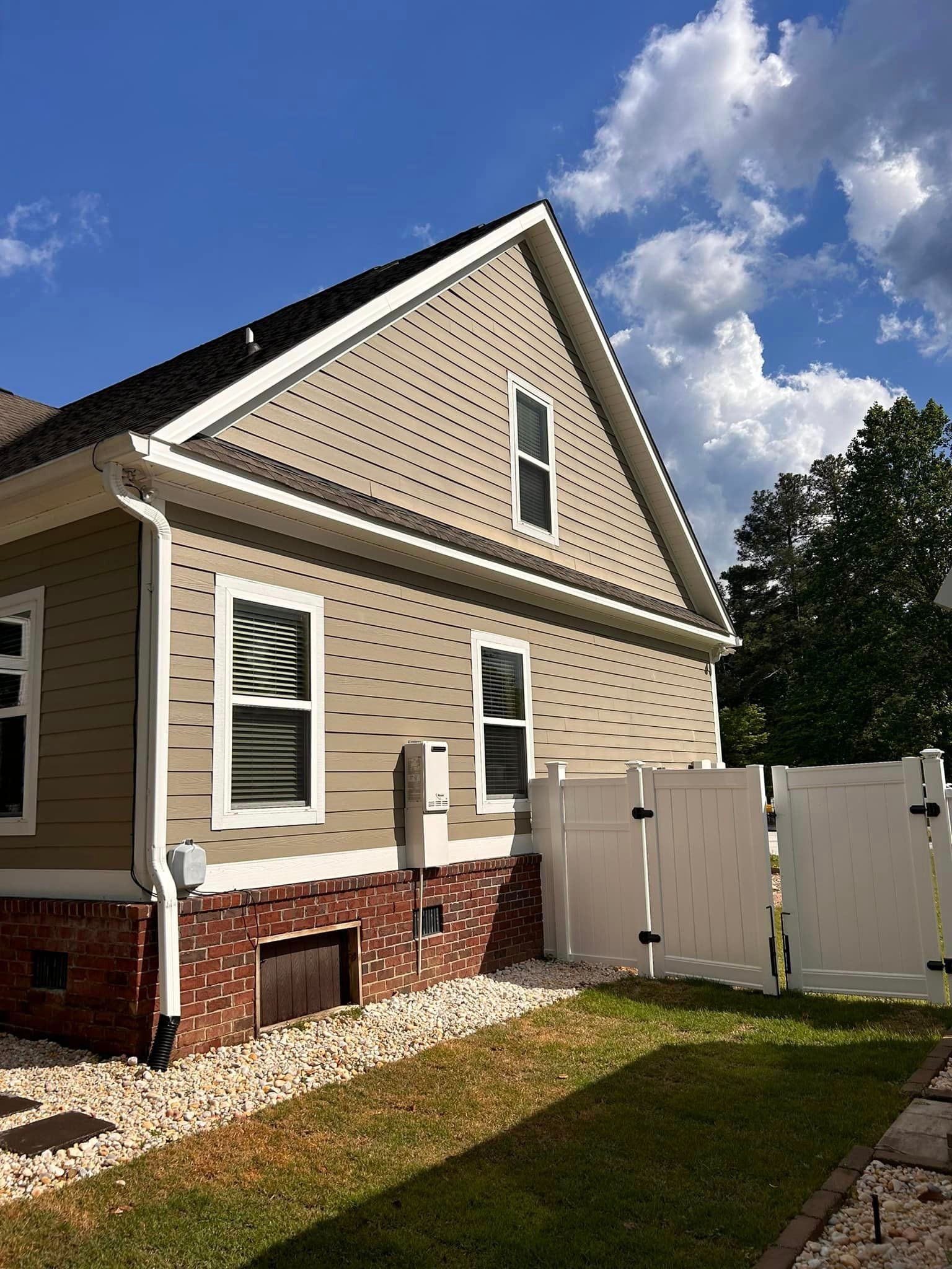 A house with a white fence in front of it