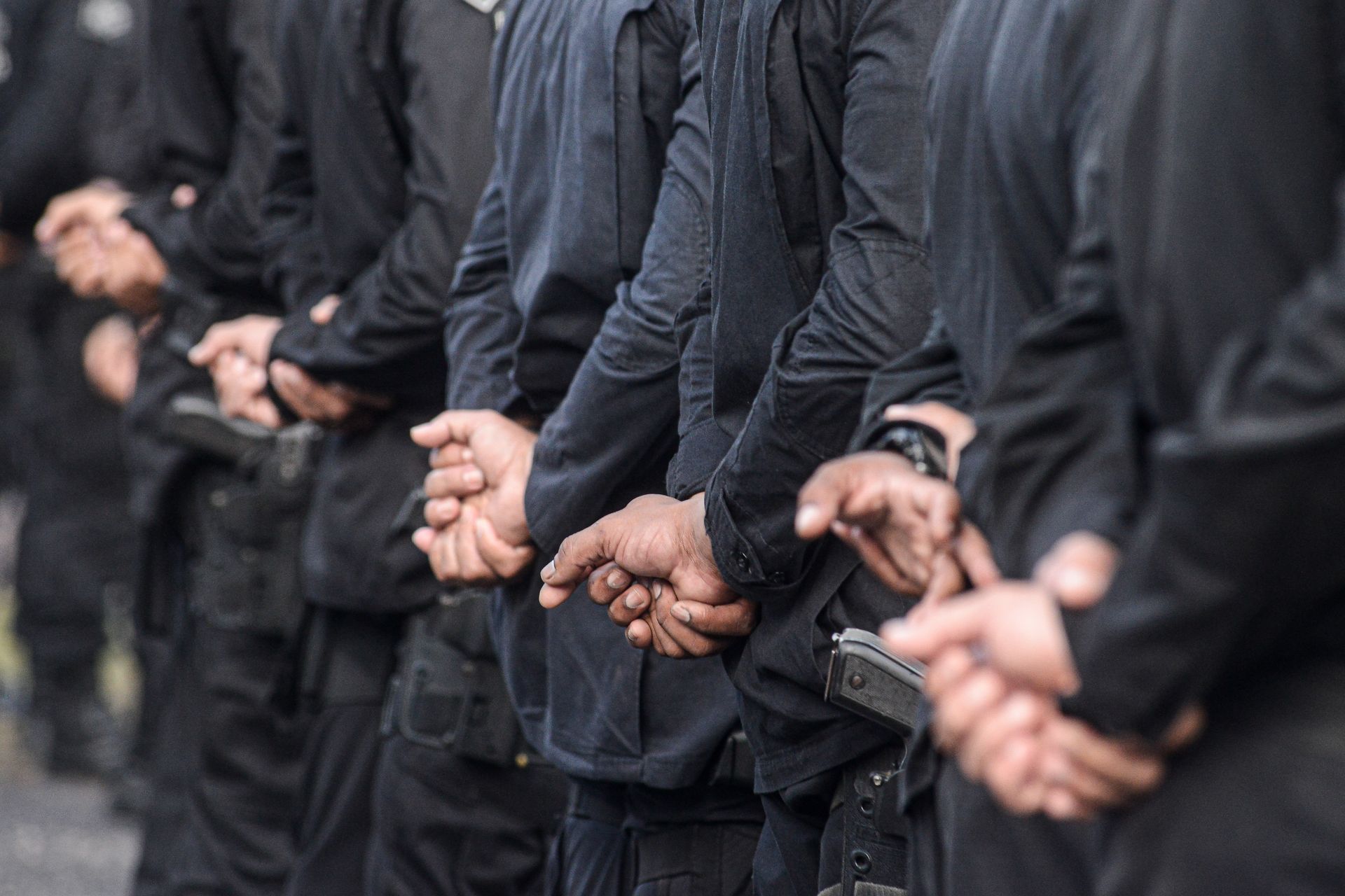 A group of security man's hand behind their back.