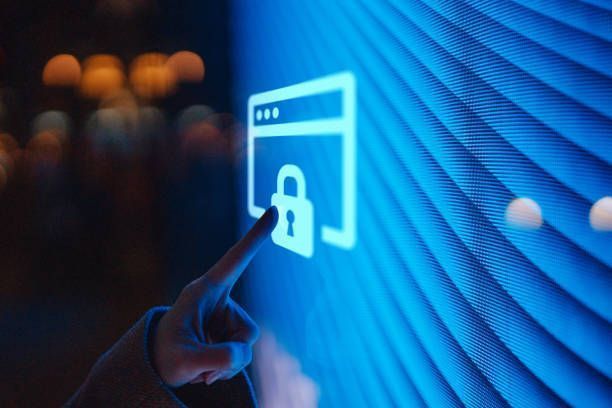 A person is pointing at a screen with a padlock on it.