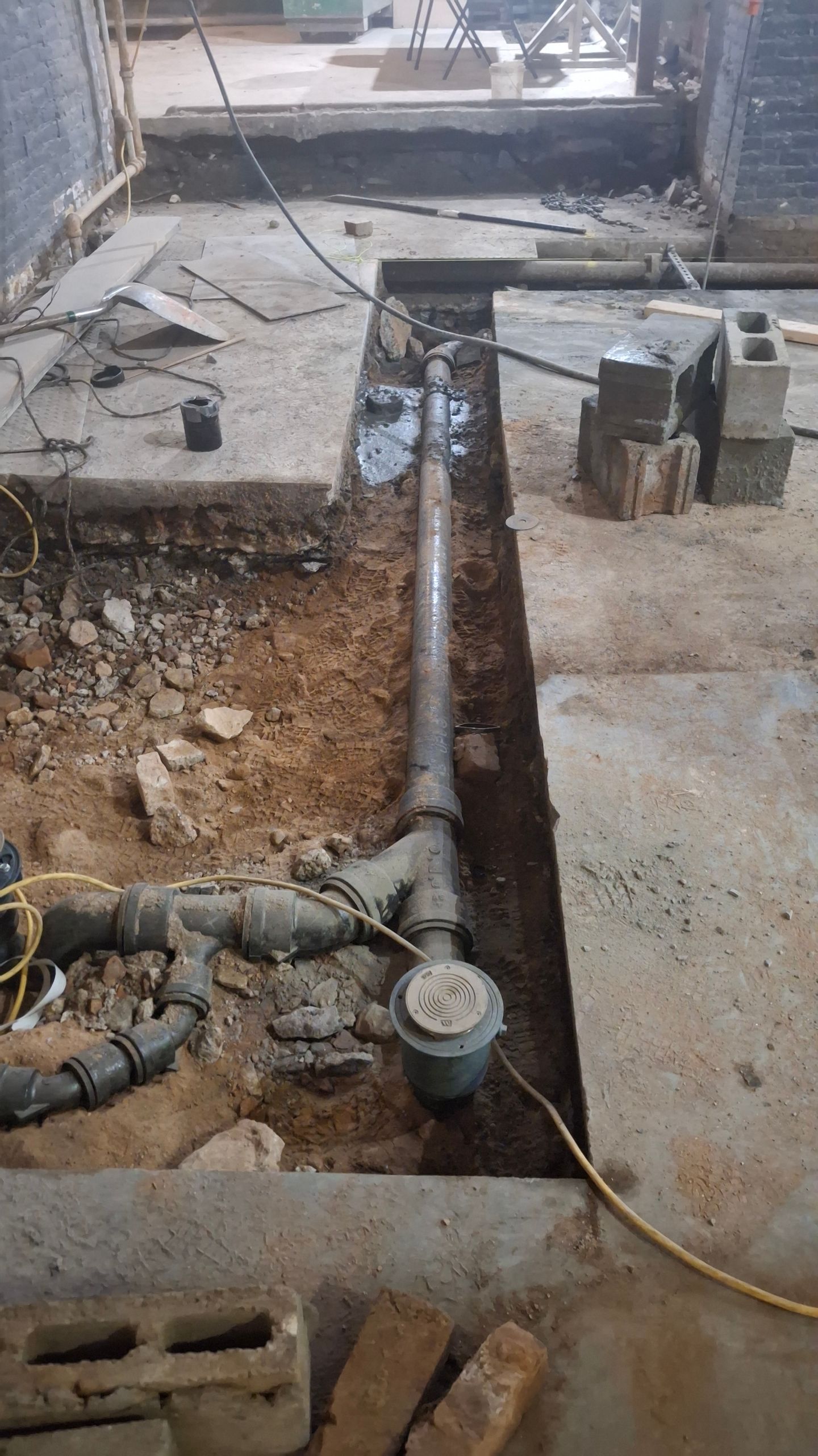 A pipe is being installed in a hole in the ground.