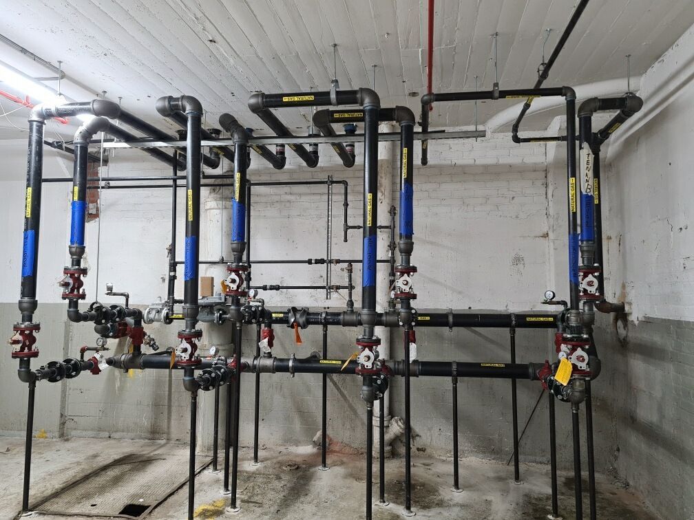 A bunch of pipes are hanging from the ceiling in a room.
