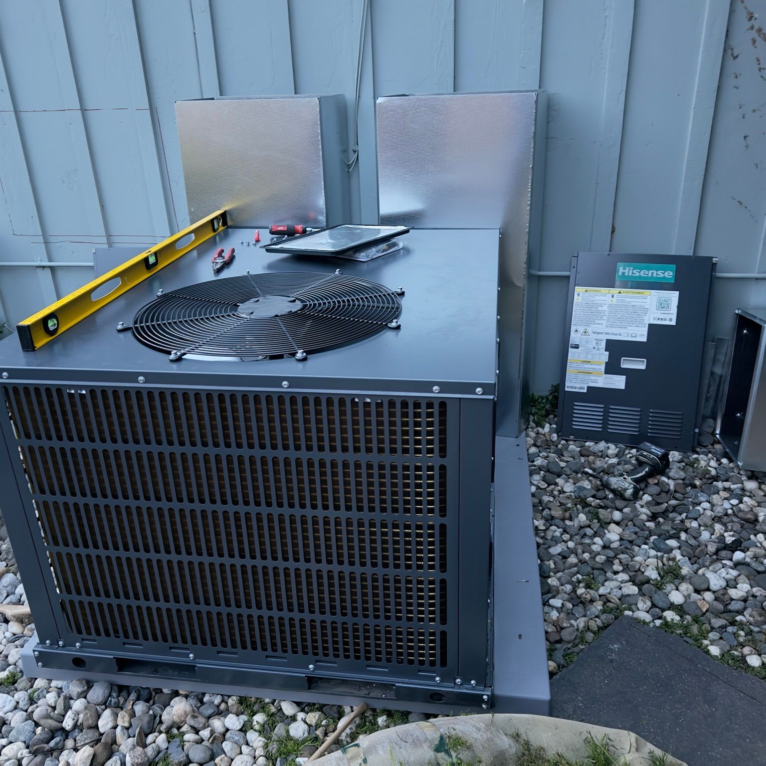 Outdoor HVAC equipment with sheet-metal duct sections being fitted