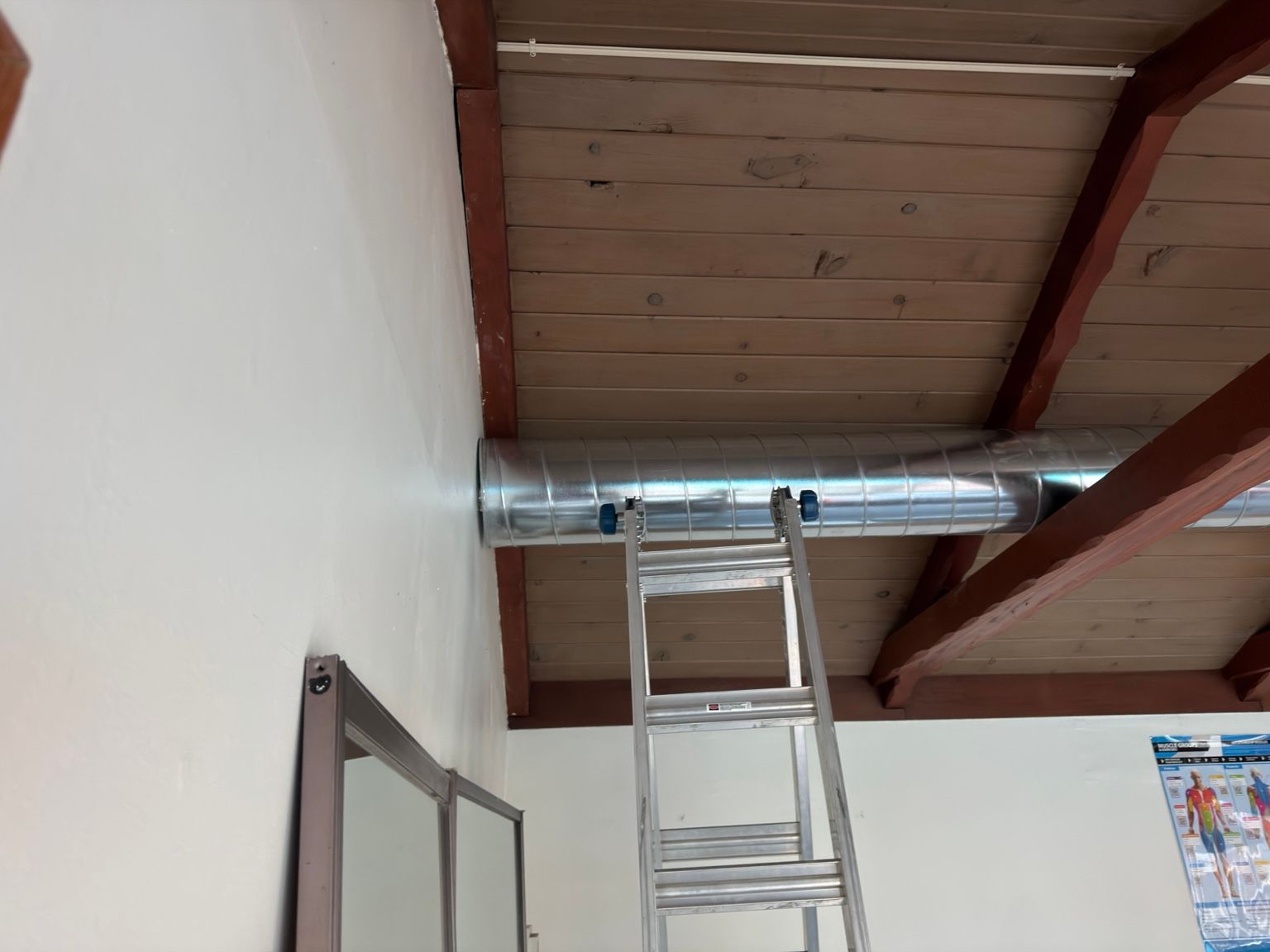 Duct connection at the wall — Capital City Comfort spiral duct installation