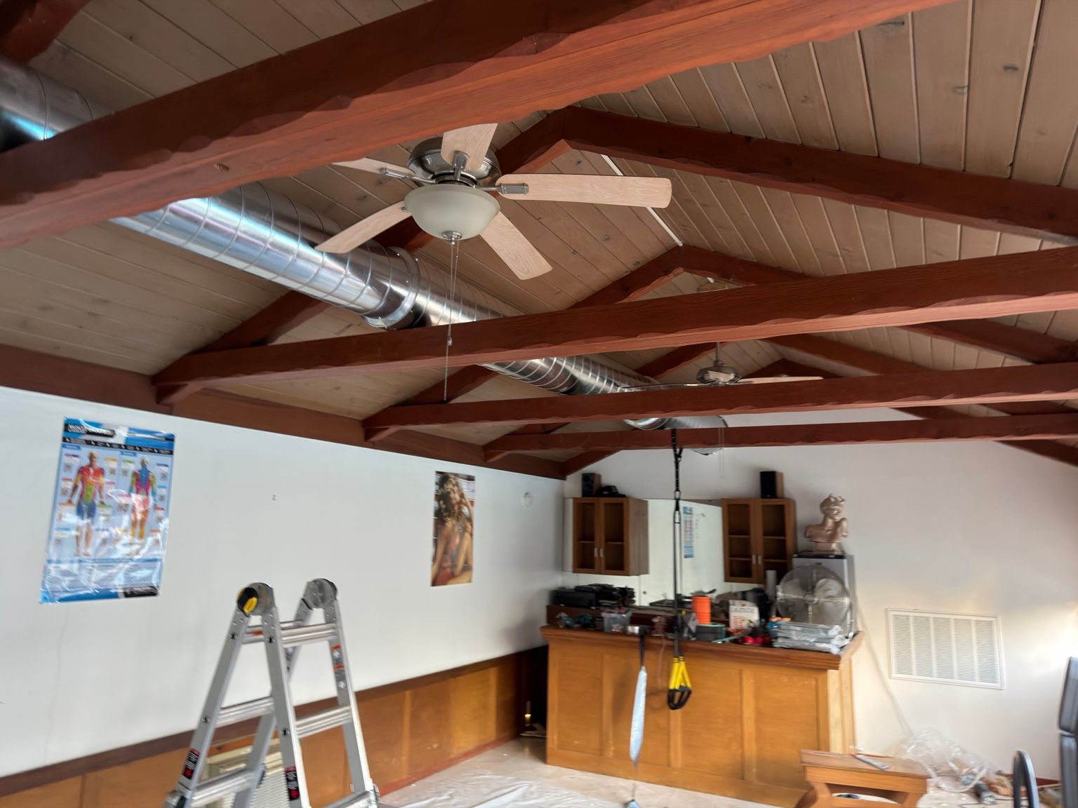 Installation progress across the room — Capital City Comfort spiral duct installation