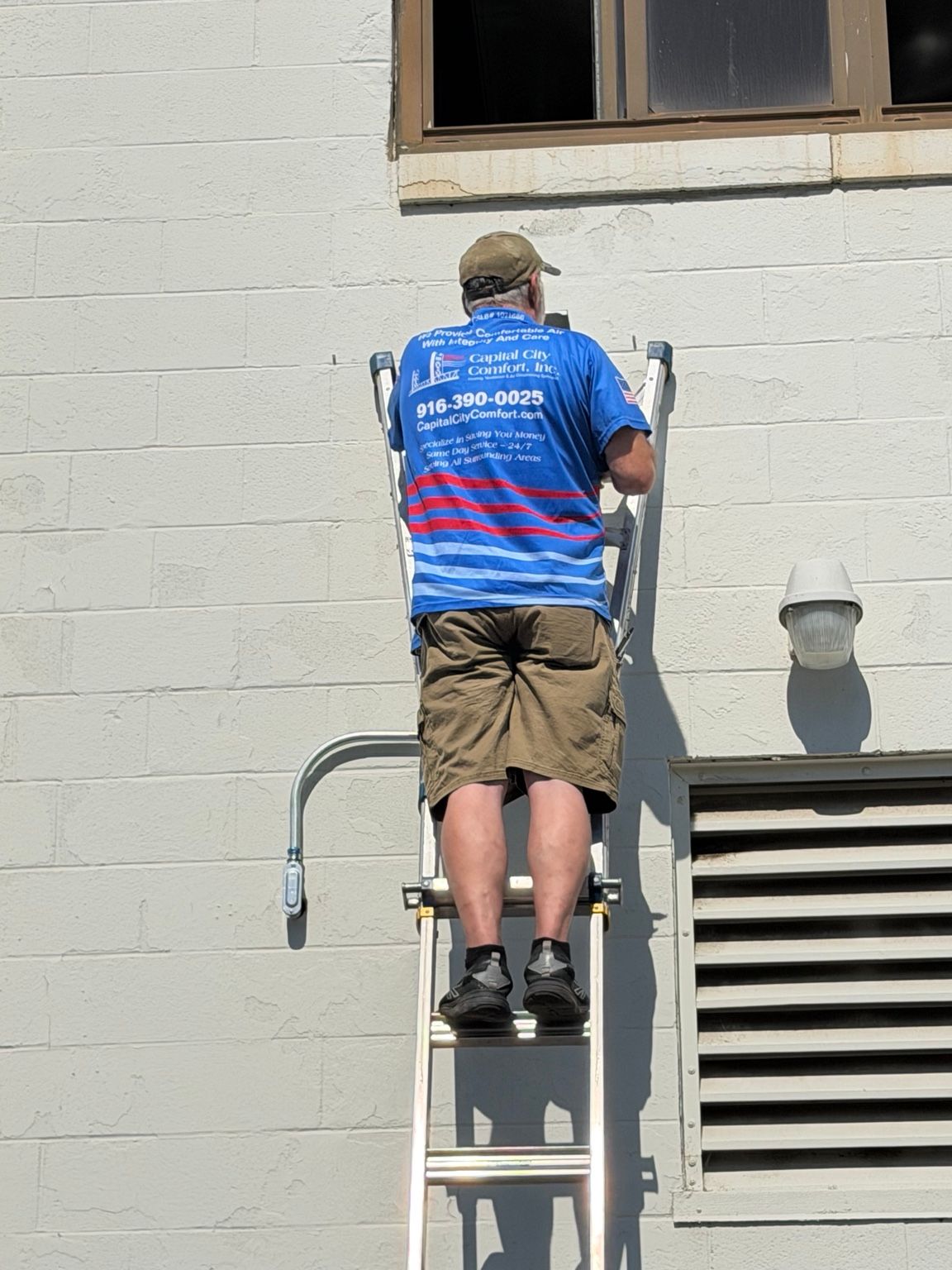 Capital City Comfort technician working on exterior HVAC installation at Air Station Sacramento