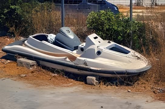 A green and white yamaha jet ski is sitting on the ground
