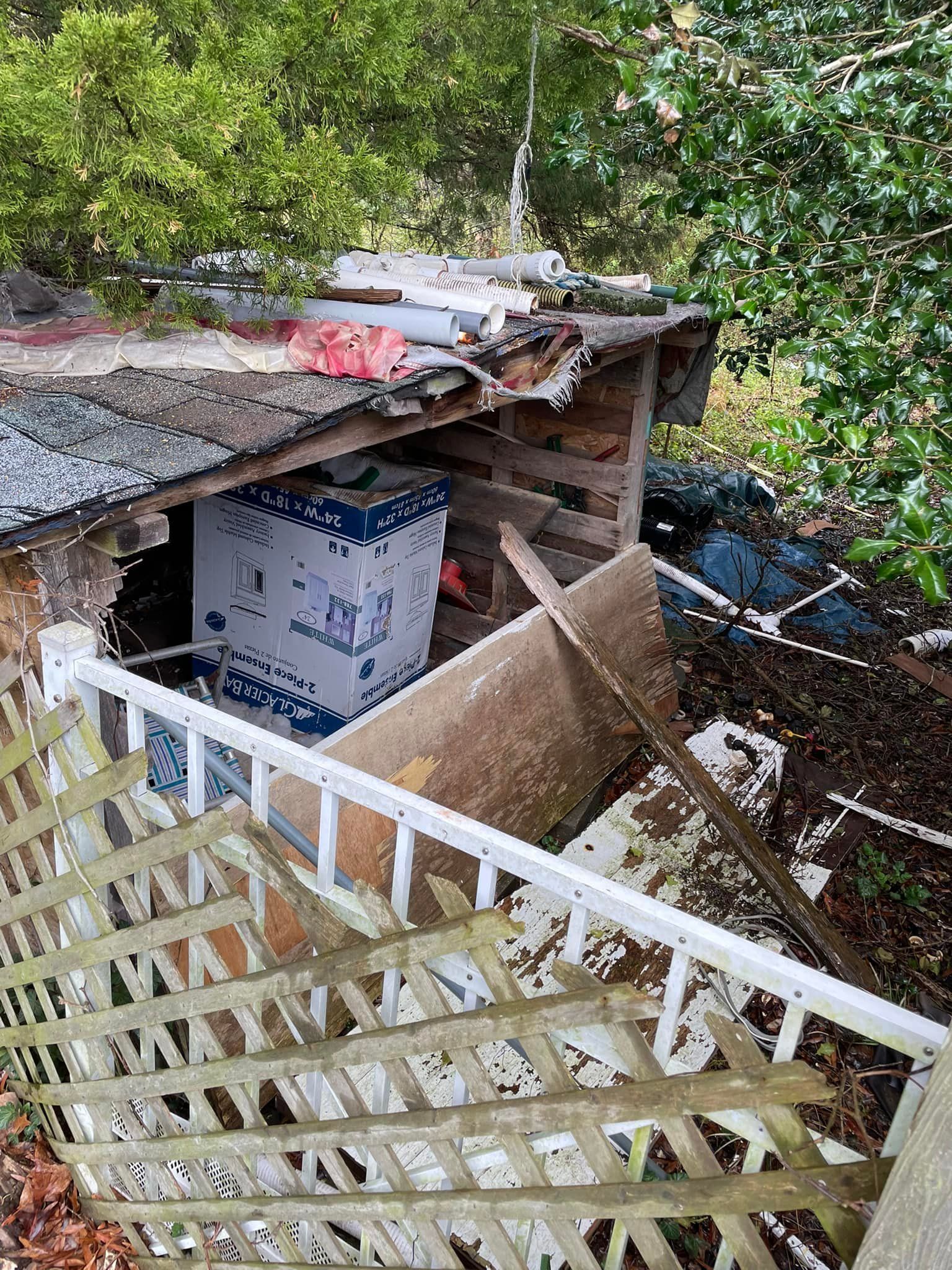 A staircase leading up to a shed with a box on top of it